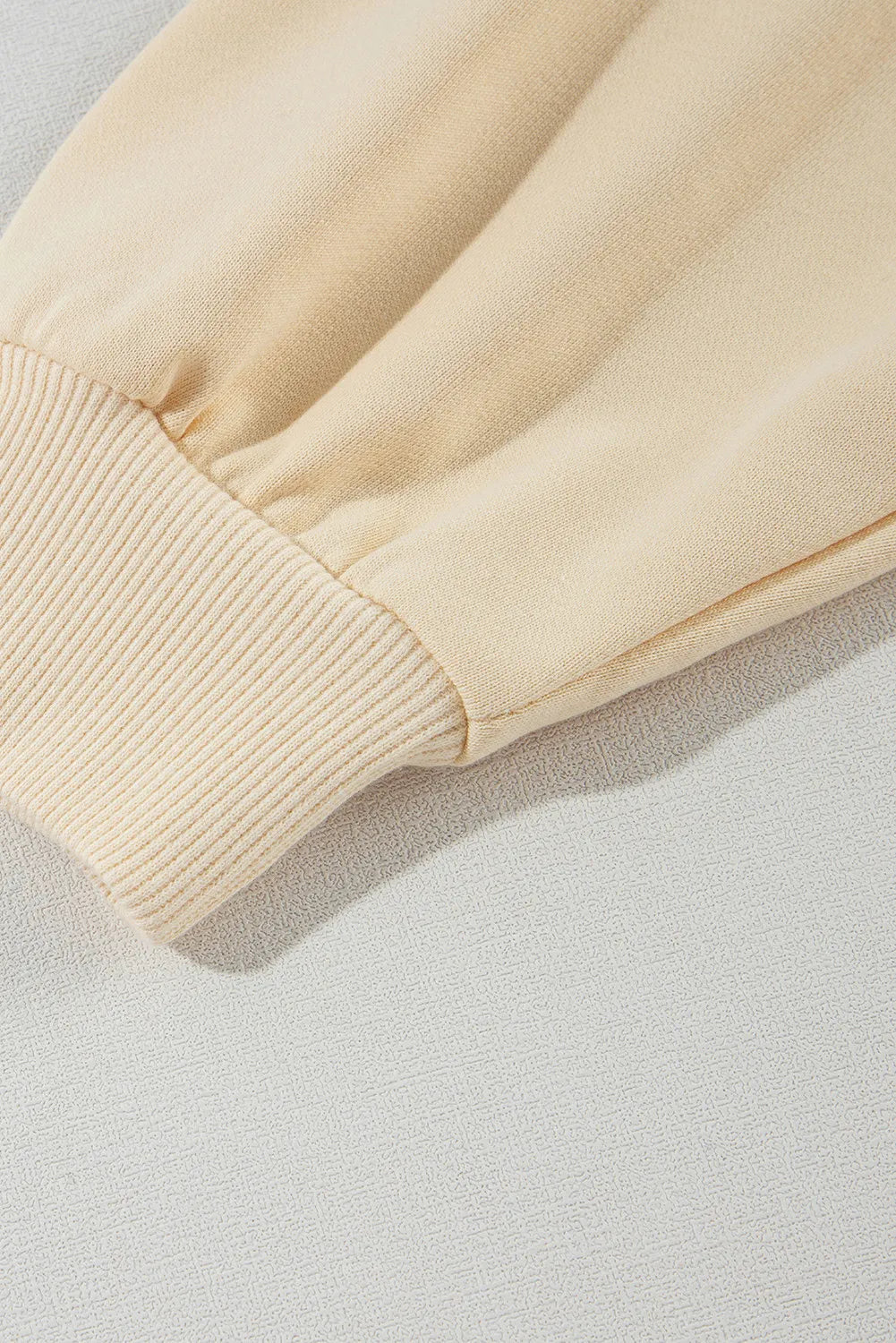 Light yellow asymmetrical collar button up sleeves off shoulder sweatshirt